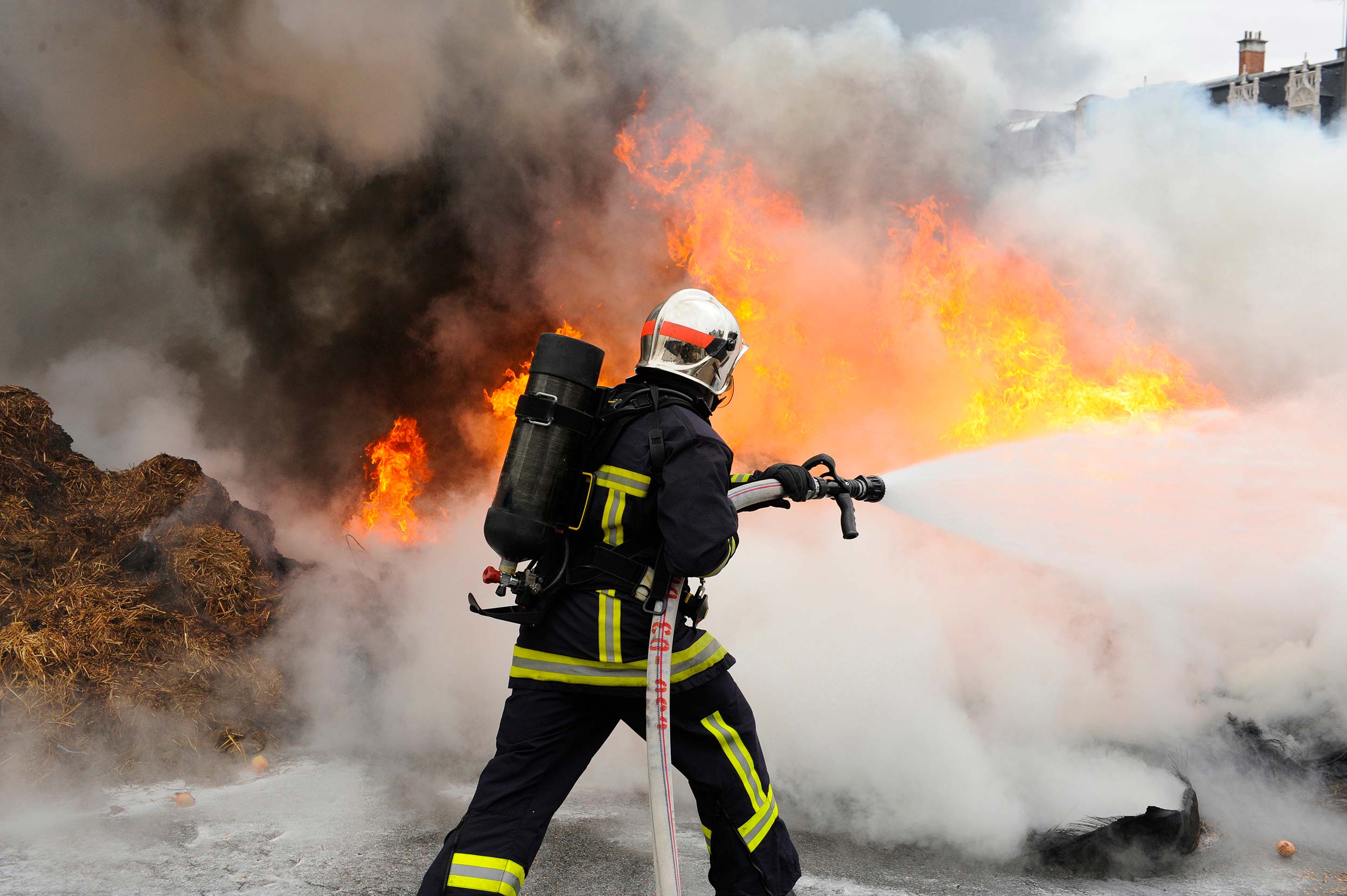stock-photo-firefighter-extinguishes-a-fire-1026947356